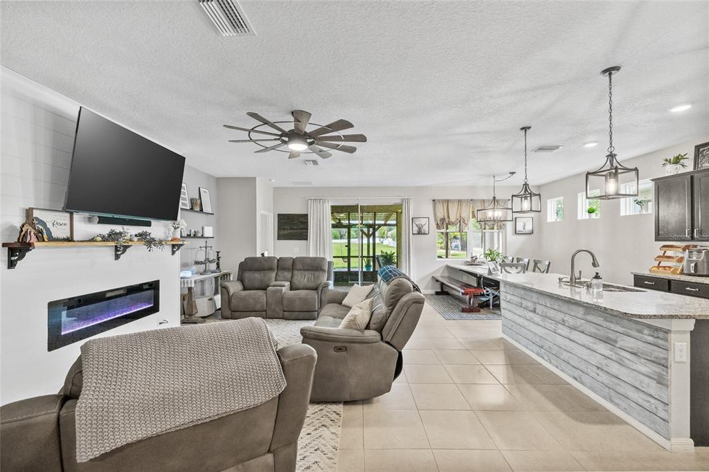 13675 Paddington Way Spring Hill, FL 34609 - Photo 8 of 36 a living room with furniture and a flat screen tv