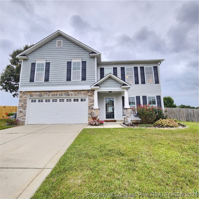 332 United Road Raeford, NC 28376 - Photo 1 of 31 a front view of a house with a yard and garage