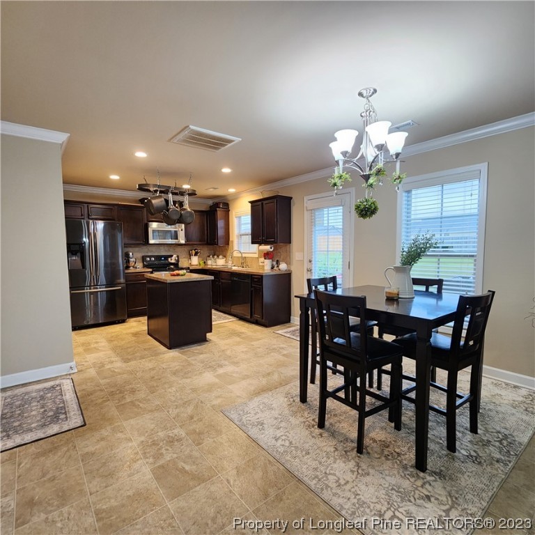 332 United Road Raeford, NC 28376 - Photo 16 of 31 a view of a dining room and a kitchen with a table chairs