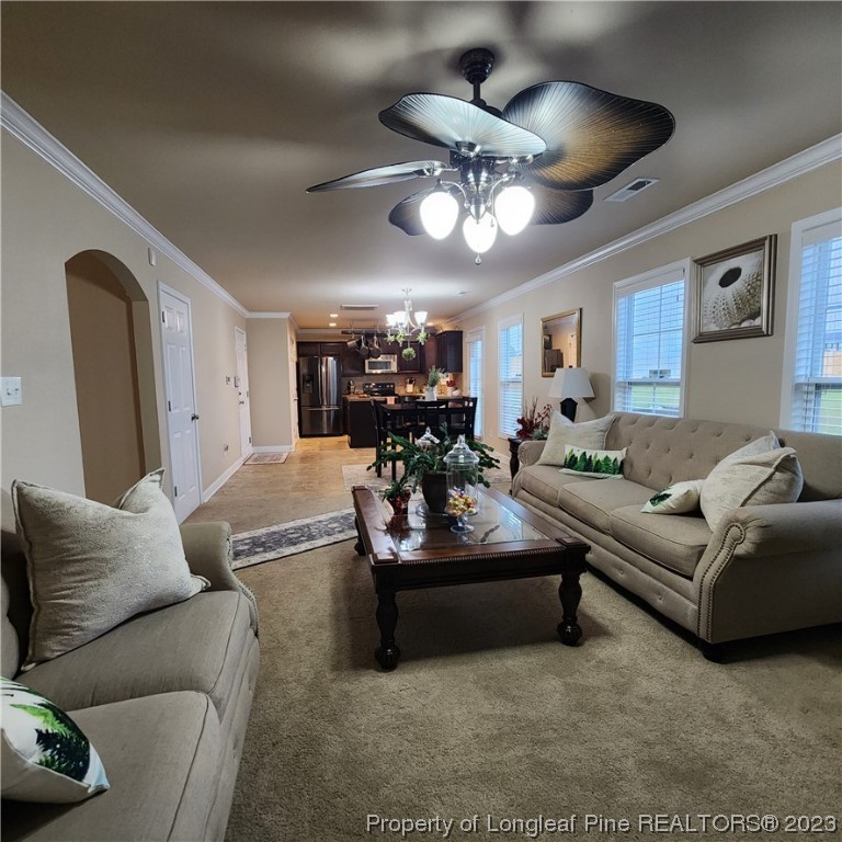 332 United Road Raeford, NC 28376 - Photo 17 of 31 a living room with furniture and a chandelier