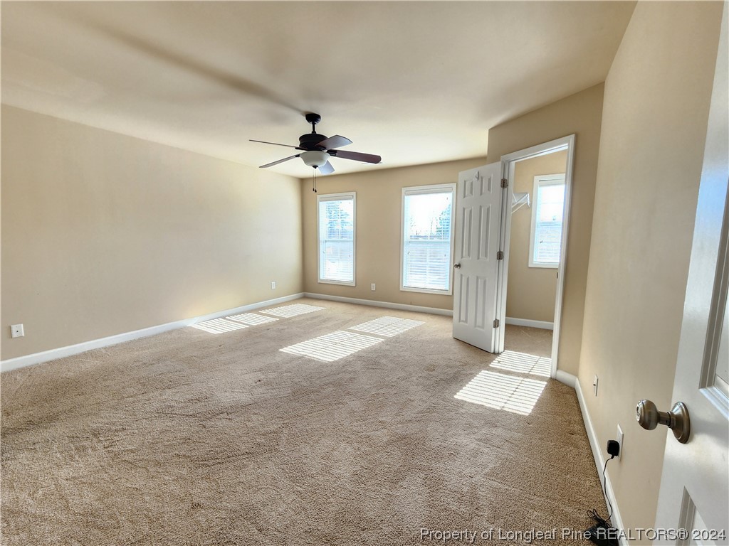 332 United Road Raeford, NC 28376 - Photo 24 of 31 a view of a big room with windows and chandelier fan