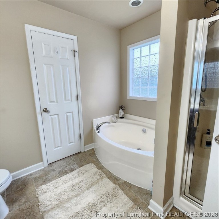 332 United Road Raeford, NC 28376 - Photo 9 of 31 a bathroom with a bathtub and a window