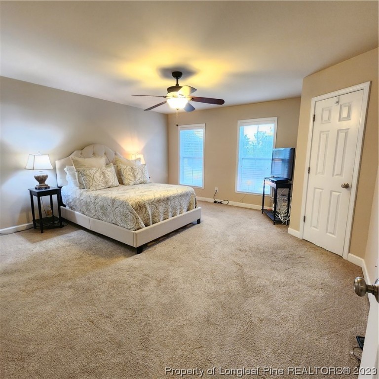 332 United Road Raeford, NC 28376 - Photo 10 of 31 a spacious bedroom with a bed and a chandelier