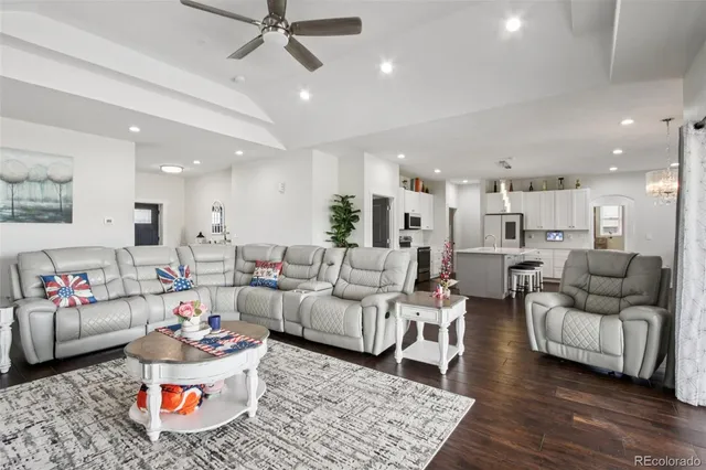 a living room with furniture and kitchen view