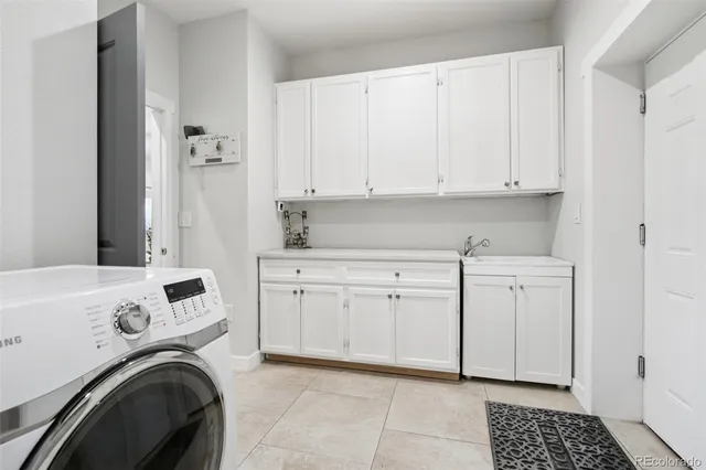 a view of a kitchen with cabinets and washer