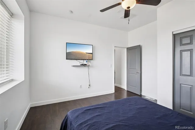 a living room with furniture a rug and a flat screen tv