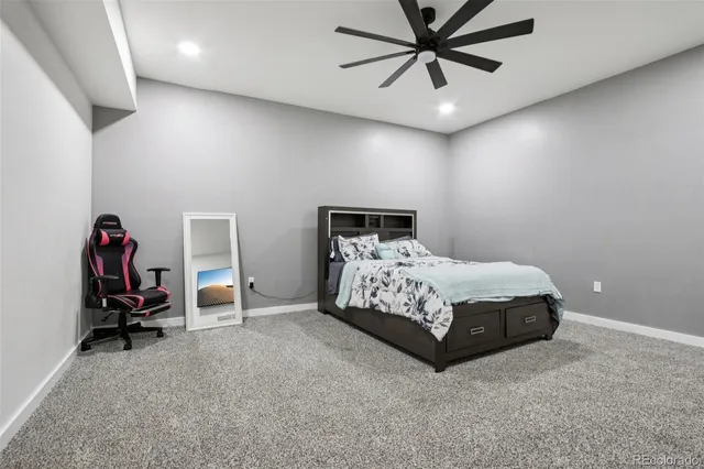 a bedroom with a bed and a ceiling fan
