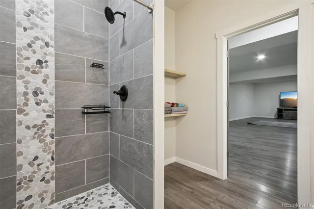 a bedroom with a bed and a chandelier fan