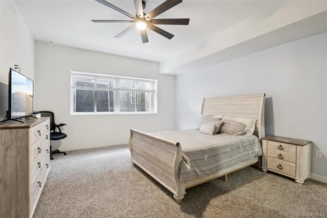 a bedroom with a bed and a baby bed