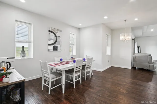 a dining room with furniture and wooden floor