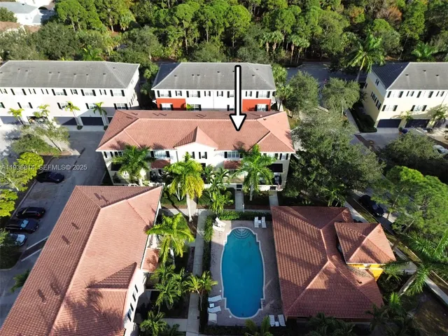 an aerial view of a house with yard swimming pool and outdoor seating