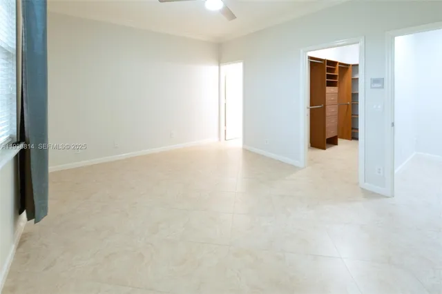 an empty room with closet and mirror