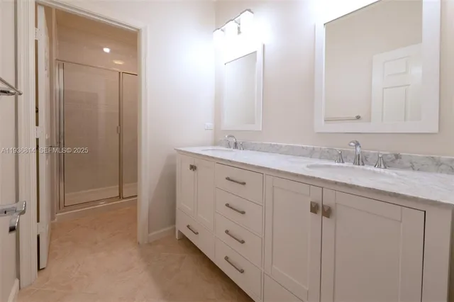 a bathroom with a granite countertop sink double and mirror