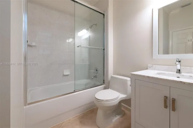 a bathroom with a toilet sink and shower