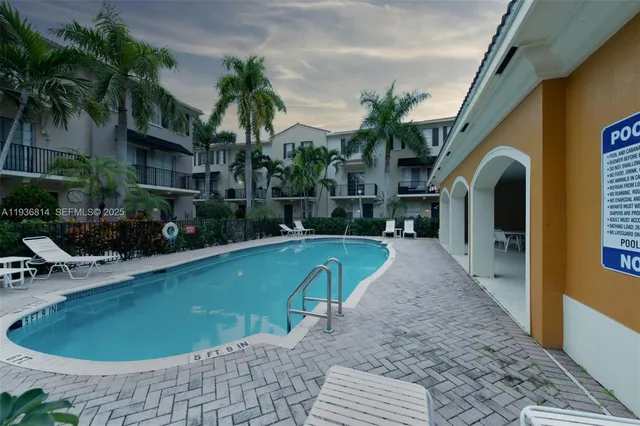 a swimming pool with outdoor seating and yard