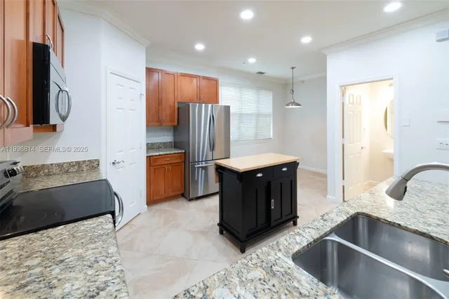 a kitchen with a sink stove and refrigerator