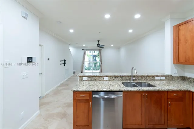 a kitchen with stainless steel appliances granite countertop a sink and a granite counter tops