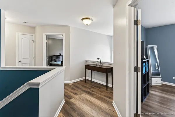 a view of a hallway and a livingroom with furniture