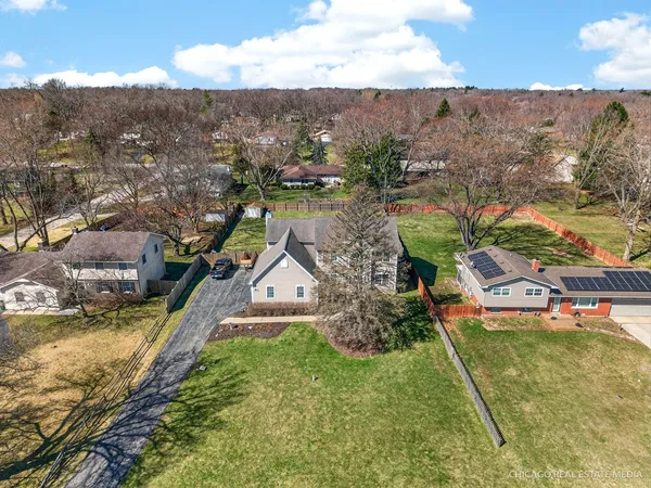 an aerial view of residential houses with outdoor space and swimming pool
