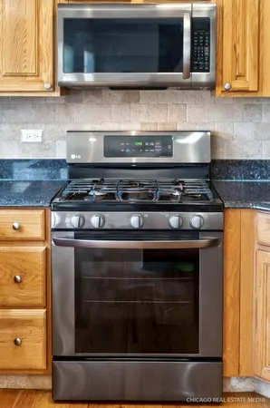 a stove top oven sitting inside of a kitchen and granite counter tops