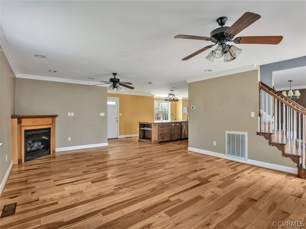 22157 Rowanty Road Carson, VA 23830 - Photo 4 of 34 a view of a livingroom with a fireplace a ceiling fan and wooden floor