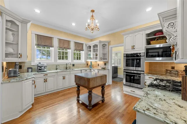 a kitchen with stainless steel appliances a sink and cabinets