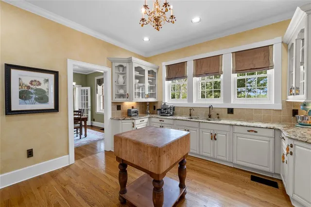 a view of a dining room with furniture wooden floor and a chandelier