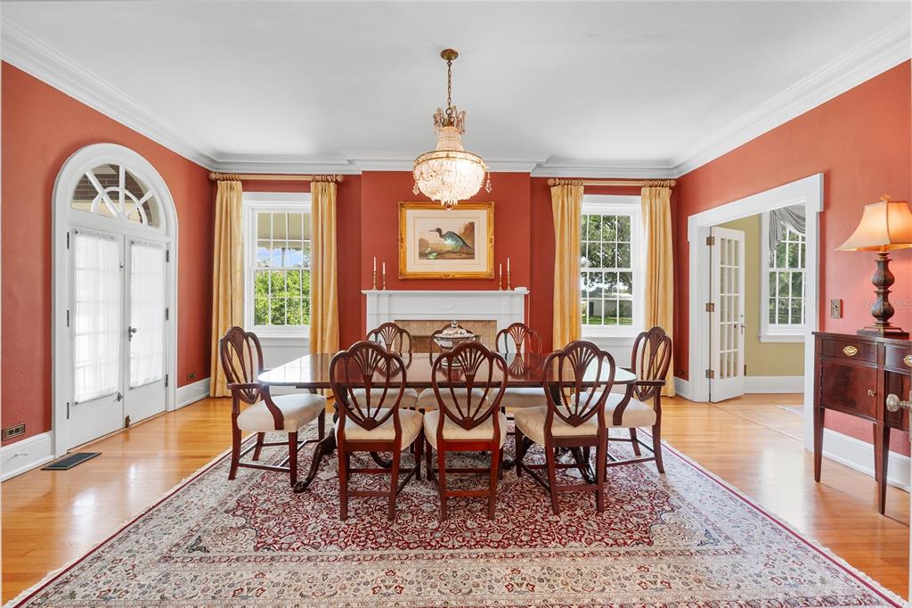 1760 Old Bartow Eagle Lake Road Bartow, FL 33830 - Photo 20 of 85 a dining room with wooden floor a chandelier a wooden table and chairs