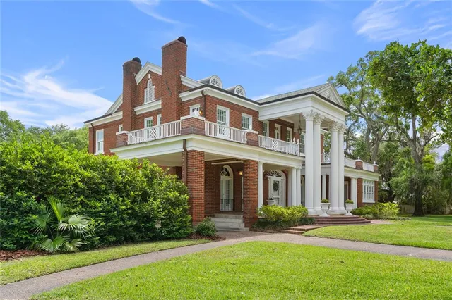 a front view of a house with a floor to ceiling windows