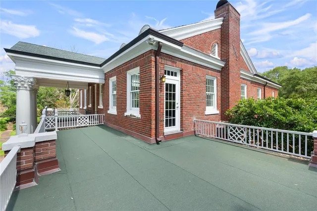a view of a yard with plants and trees
