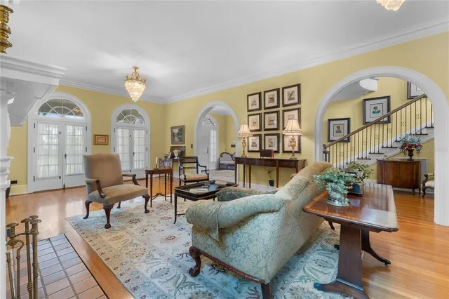 a kitchen with stainless steel appliances granite countertop a stove top oven a sink dishwasher and white cabinets with wooden floor