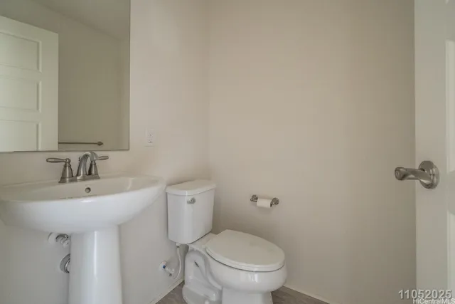 a bathroom with a sink toilet and a mirror