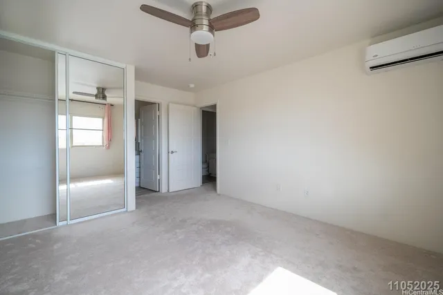 an empty room with fan and entrance