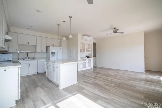 a large kitchen with cabinets wooden floor and stainless steel appliances