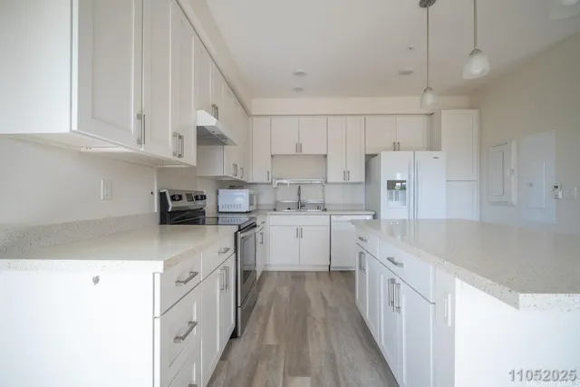 a kitchen with cabinets and stainless steel appliances