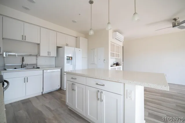 a kitchen with white cabinets sink and white appliances