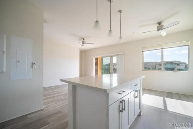a kitchen with white cabinets and window