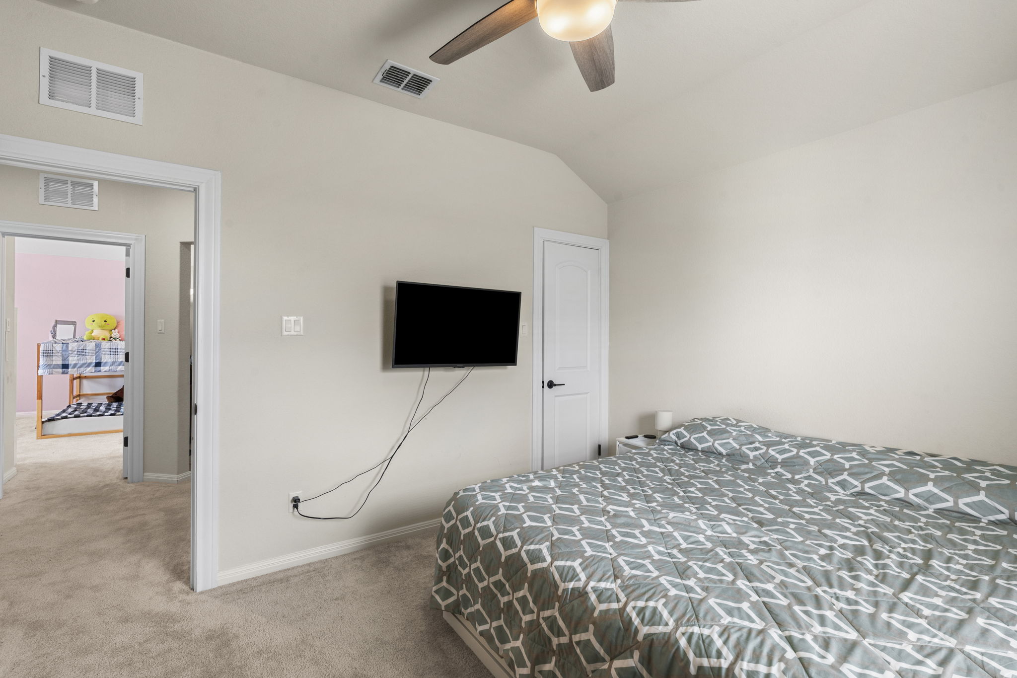 548 Purple Heart Drive Buda, TX 78610 - Photo 24 of 35 A well-appointed bedroom features soft carpeting and a vaulted ceiling.