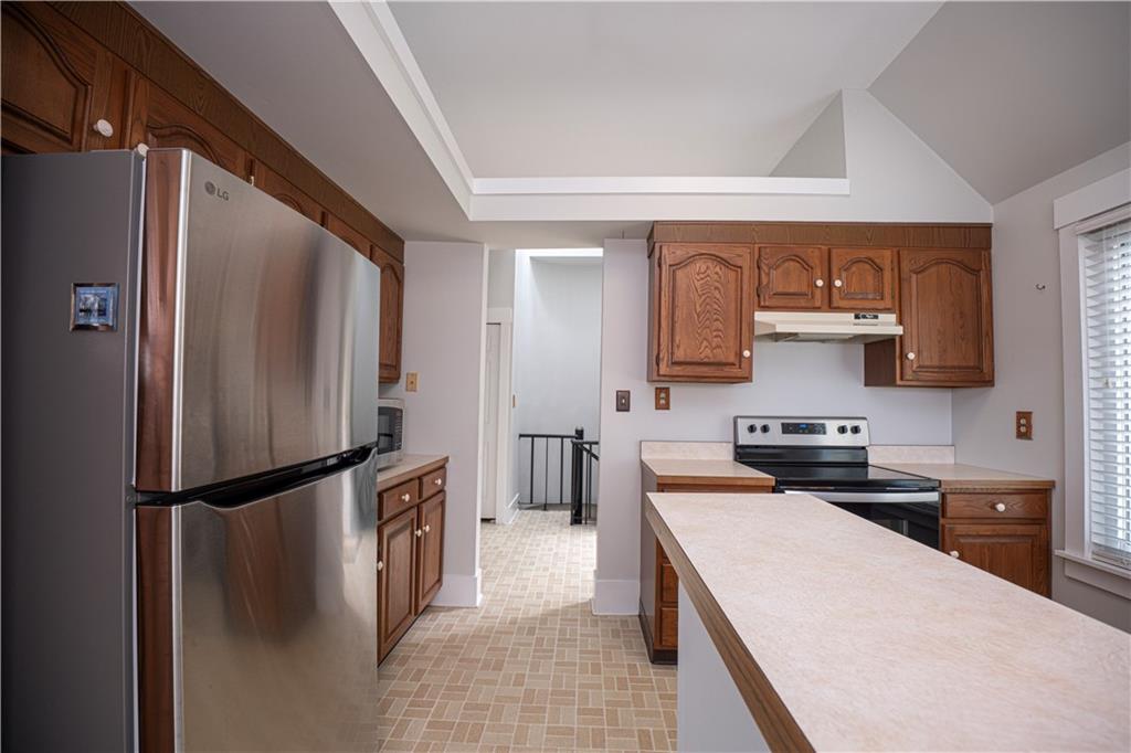 15 Ridgemead Fields Drive Plum, PA 15147 - Photo 11 of 32 a kitchen with a refrigerator a stove top oven and a sink