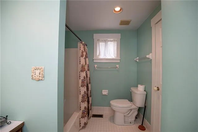 a bathroom with a toilet a sink and shower