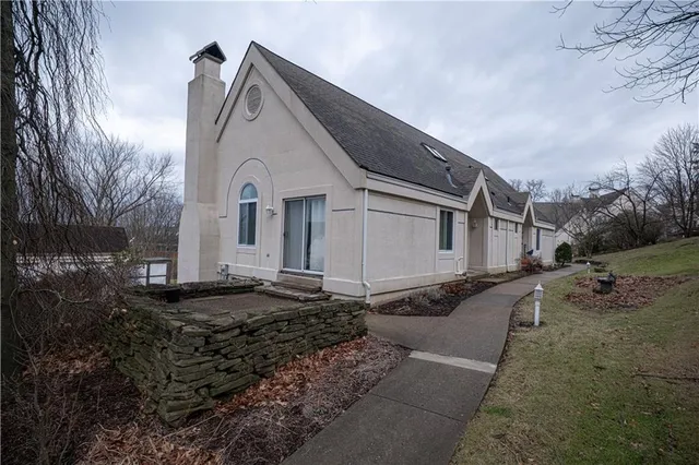 a view of a white house with large windows