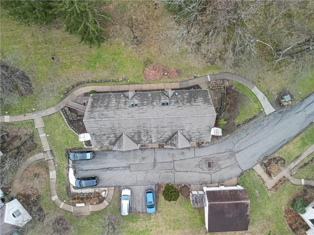 an aerial view of a residential houses with outdoor space