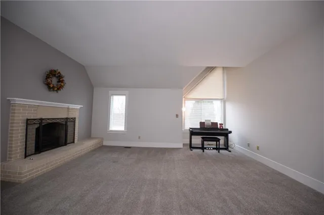 a view of a livingroom with furniture and a fireplace