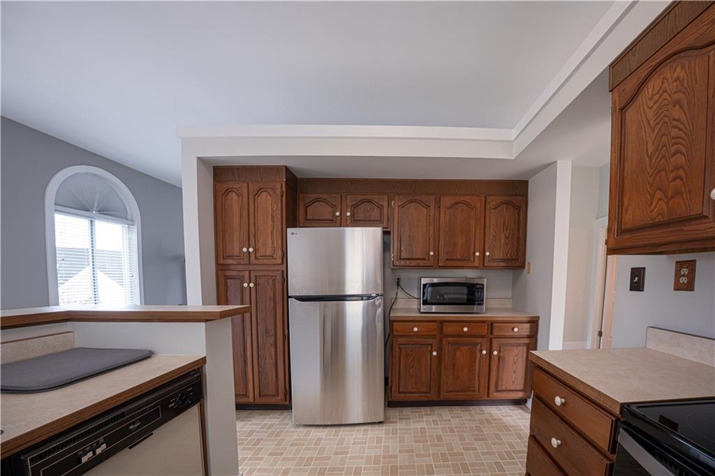 15 Ridgemead Fields Drive Plum, PA 15147 - Photo 9 of 32 a kitchen with a refrigerator and a stove