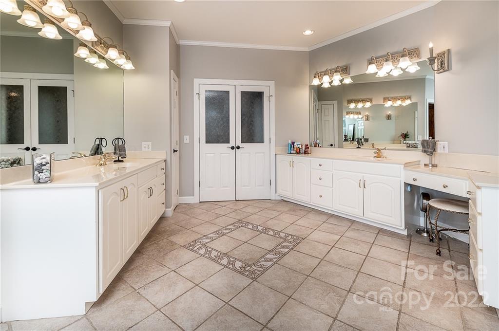 3802 Gordon Street Terrell, NC 28682 - Photo 14 of 48 a large white bathroom with a sink a large mirror and a shower