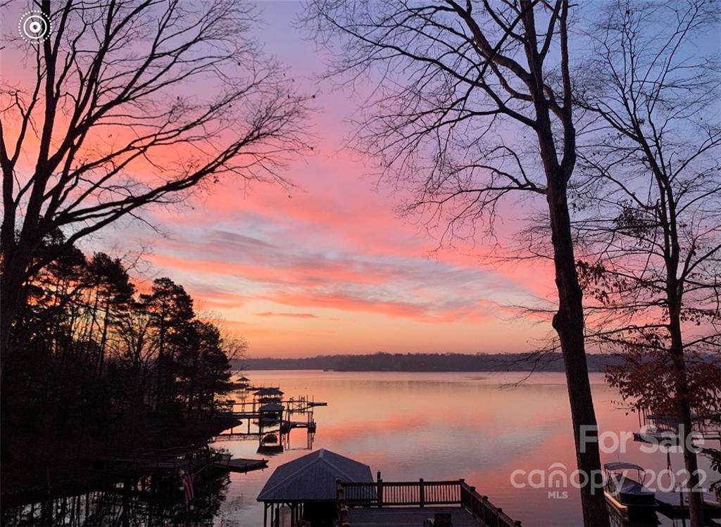 3802 Gordon Street Terrell, NC 28682 - Photo 16 of 48 a view of a lake with a table and chair under an umbrella