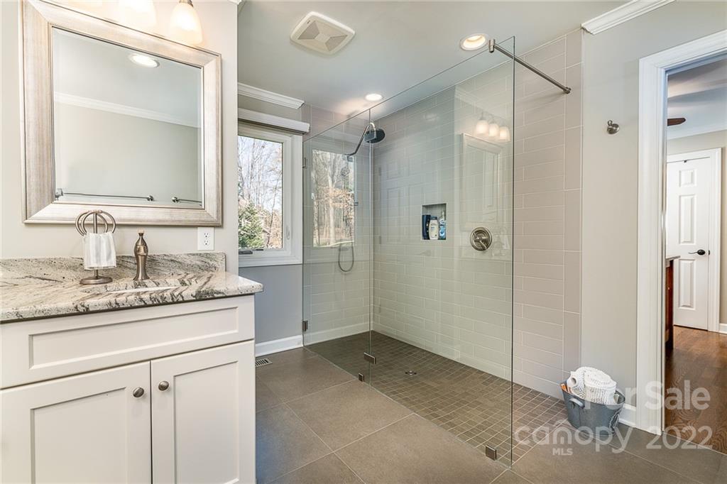 3802 Gordon Street Terrell, NC 28682 - Photo 34 of 48 a bathroom with a granite countertop sink a mirror and a shower