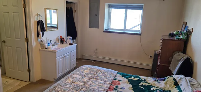 a bedroom with a bed and a dresser