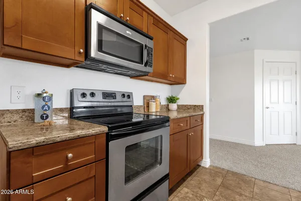a kitchen with stainless steel appliances granite countertop cabinets stove a sink and a microwave