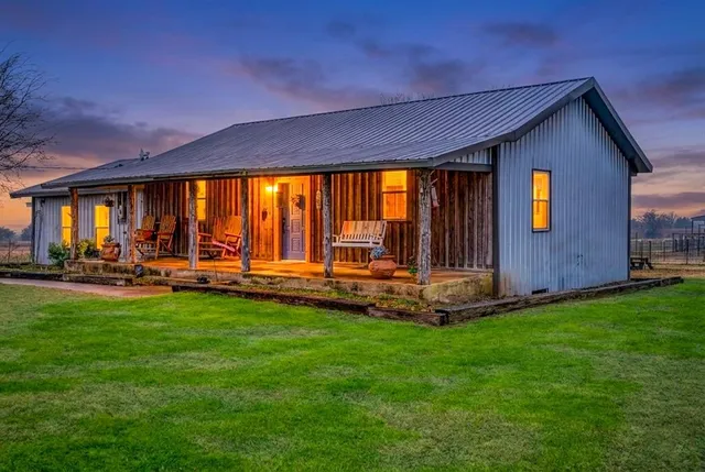 a view of a backyard with sitting area and garden